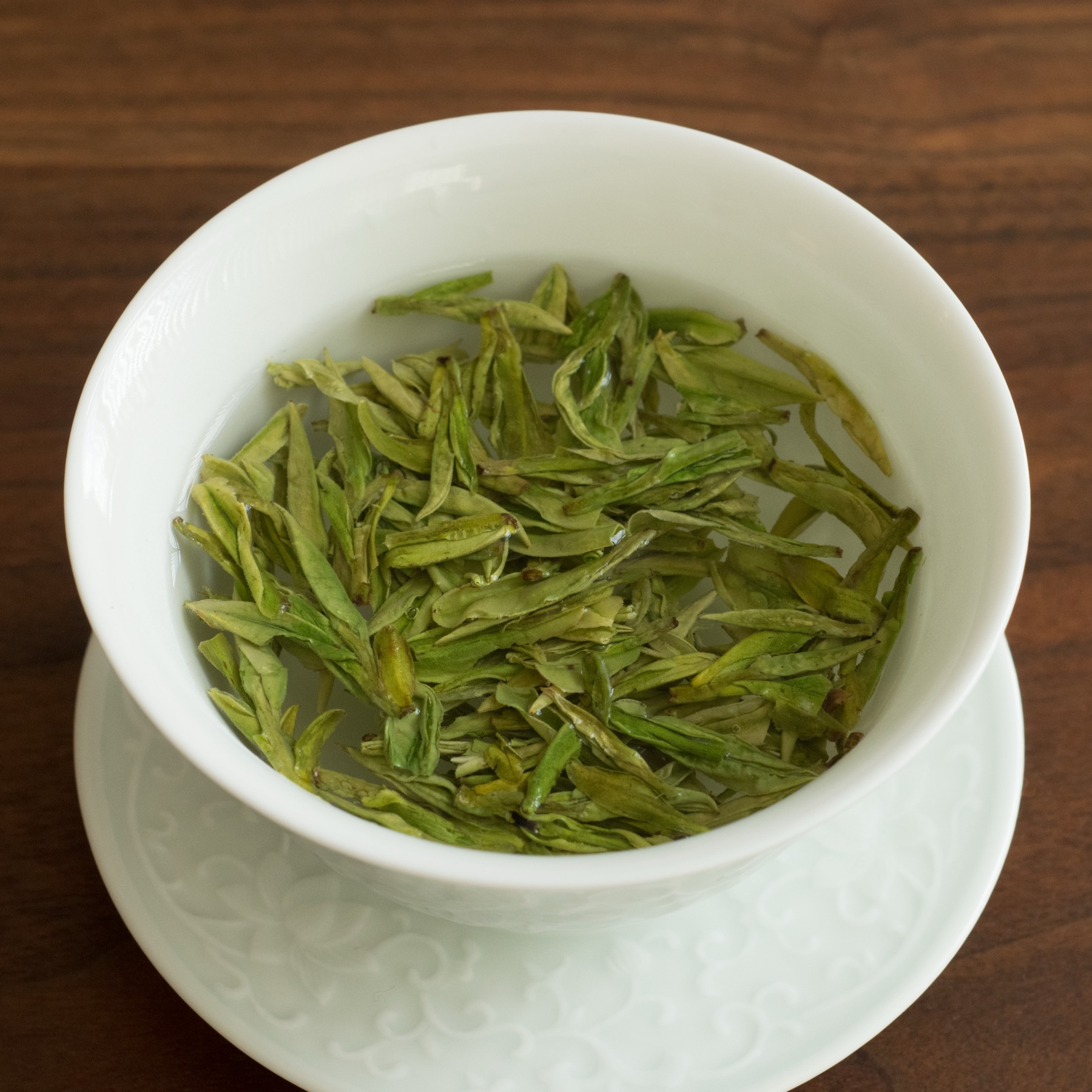 Longjing tea steeping in a porcelain gaiwan